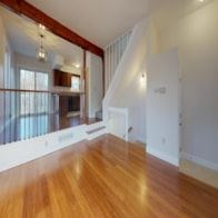 Pepperell apartment for rent - A room with wooden floors and white walls.