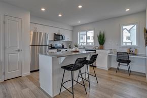 Edmonton apartment for rent - a kitchen with an island and two bar stools