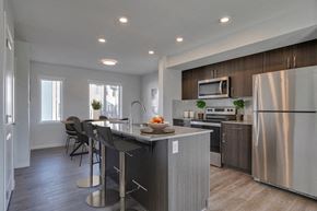 Edmonton apartment for rent - a kitchen with a center island and stainless steel appliances