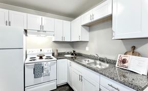Colorado Springs apartment for rent - the preserve at ballantyne commons apartment kitchen with white appliances