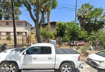 Pasadena house for rent - A silver pickup truck is parked on the side of a street.
