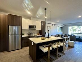Saskatoon apartment for rent - A modern kitchen with a large island and stainless steel appliances.