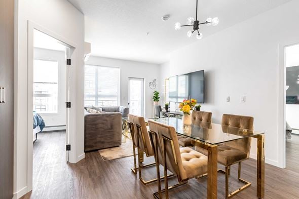 Saskatoon apartment for rent - an open living room and dining room with a table and chairs