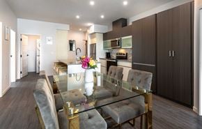 Saskatoon apartment for rent - a dining room and kitchen with a glass table and chairs