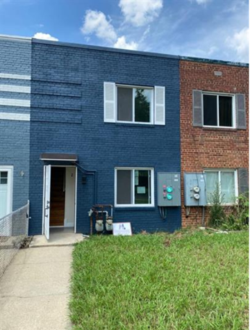 Washington apartment for rent - a blue building with a sidewalk in front of it