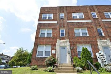Washington apartment for rent - a red brick building with a blue door and stairs