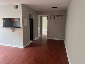 Washington apartment for rent - a large empty living room with a wood floor