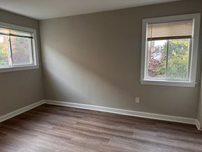 Washington apartment for rent - a living room with wooden floors and two windows