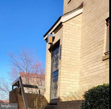Washington apartment for rent - a brick building with a barred window and stairs