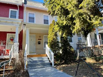 Washington apartment for rent - a house with a porch and a tree in front of it