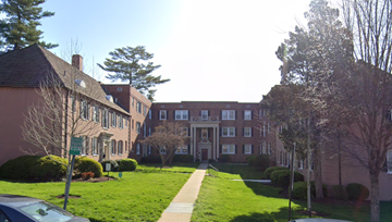 Washington apartment for rent - the front of a building with a lawn and trees