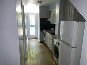 Washington apartment for rent - an empty kitchen with a washer and dryer in it