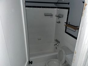 Washington apartment for rent - a bathroom with a toilet and a tub and a sink