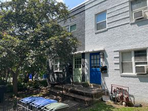 Washington apartment for rent - the front of an apartment building with a blue door and a porch