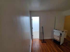 Washington apartment for rent - A room with a white wall and a wooden floor.