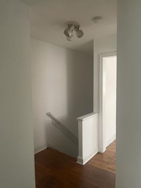 Washington apartment for rent - A white hallway with a light on the ceiling.
