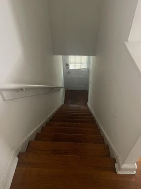Washington apartment for rent - A long flight of wooden stairs leads to a door at the end.