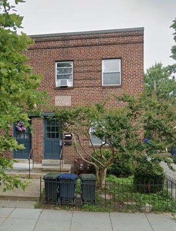 Washington apartment for rent - a brick building with three trash cans in front of it