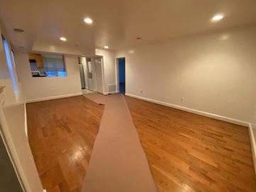 Washington apartment for rent - an empty living room with wood floors and a large rug