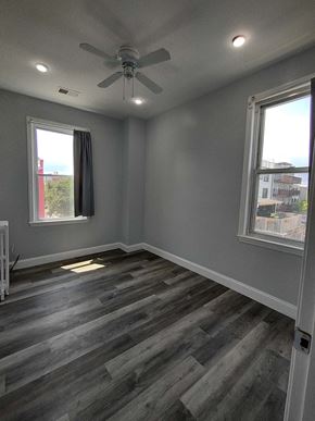 Washington apartment for rent - a living room with wood floors and a ceiling fan