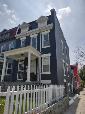 Washington apartment for rent - a blue house with a white fence in front of it