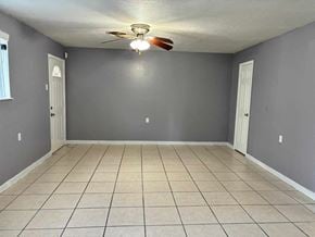 New Orleans apartment for rent - a empty living room with a ceiling fan and a tiled floor