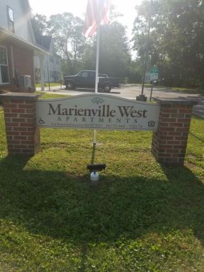 Marienville apartment for rent - a street sign in front of a house with an flag