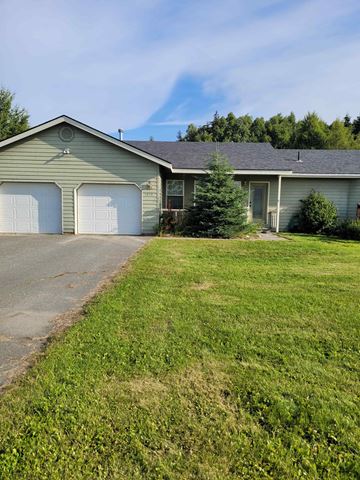 Kenai house for rent - a large green house with a lawn in front of it
