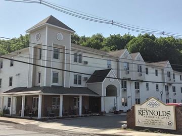 Troy apartment for rent - a large white building with a sign in front of it
