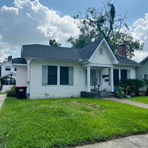 Lafayette apartment for rent - A white house with a grey roof and a tree in front.