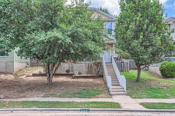Austin house for rent - a house with stairs and trees in front of it