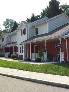 Albion apartment for rent - a red and white house with a porch and a sidewalk