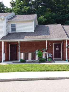 Albion apartment for rent - a red brick house with a porch and a porch swing