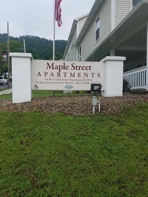 Emporium apartment for rent - a sign for maple street apartments in front of a building
