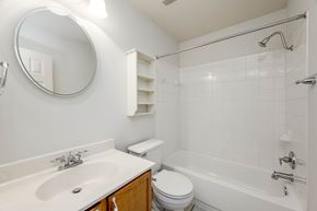 Pflugerville apartment for rent - A white bathroom with a sink, toilet, and bathtub.