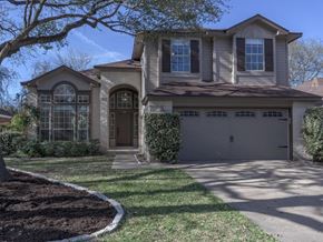 Cedar Park apartment for rent - A house with a brown door and a grey garage door.