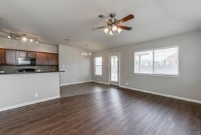 Leander apartment for rent - A spacious living room with a ceiling fan and hardwood floors.
