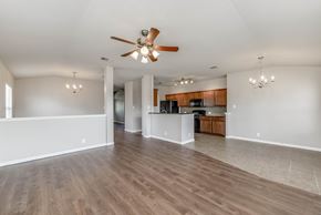 Leander apartment for rent - A spacious room with a ceiling fan and wooden flooring.