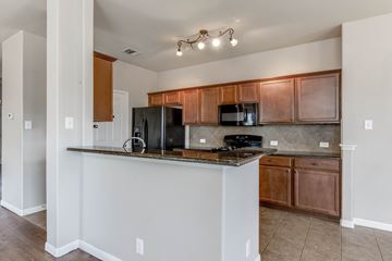 Leander apartment for rent - A kitchen with a white counter and brown cabinets.