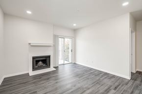 Austin apartment for rent - A spacious room with a fireplace and sliding glass doors.
