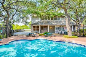 Austin apartment for rent - A pool in front of a house with a tree in front of the house.