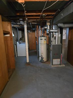 Saint Ann house for rent - a view of the basement of a home with a furnace and other equipment