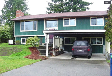 Snohomish house for rent - A green house with a car parked in front.