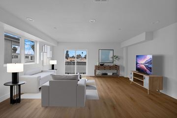 Los Angeles apartment for rent - a living room with white couches and a television