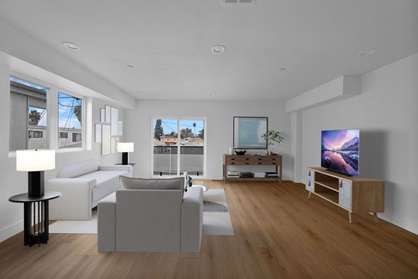 Los Angeles apartment for rent - a living room with white couches and a television