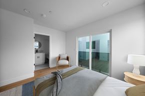 Los Angeles apartment for rent - a bedroom with a large bed and a sliding glass door