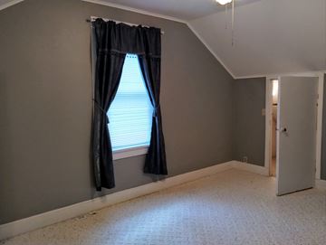 Mascoutah house for rent - a living room with a window with black curtains