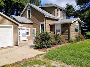 Mascoutah house for rent - a brown house with a driveway and a white garage door