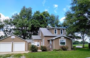 Mascoutah house for rent - a house with a garage and a yard with trees
