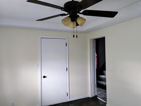 Mascoutah house for rent - a bedroom with white walls and a ceiling fan and a closet